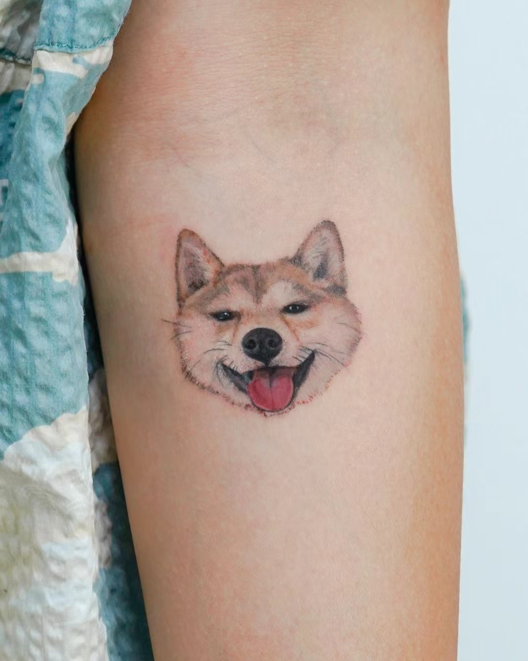 Small dog portrait tattoo in warm colour