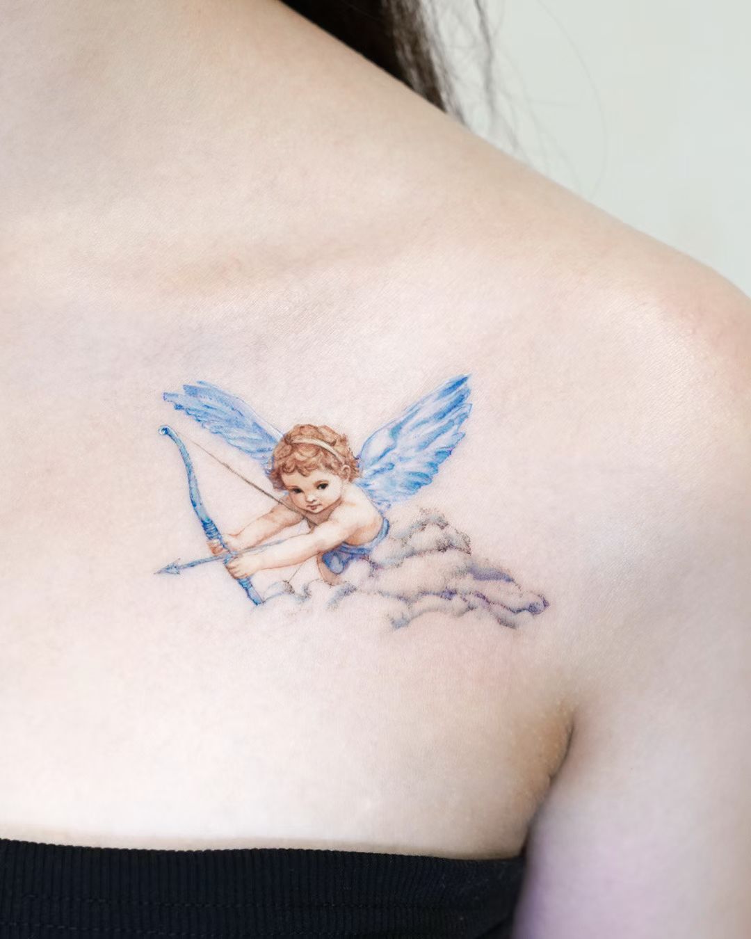 Soft cherub tattoo on the shoulder