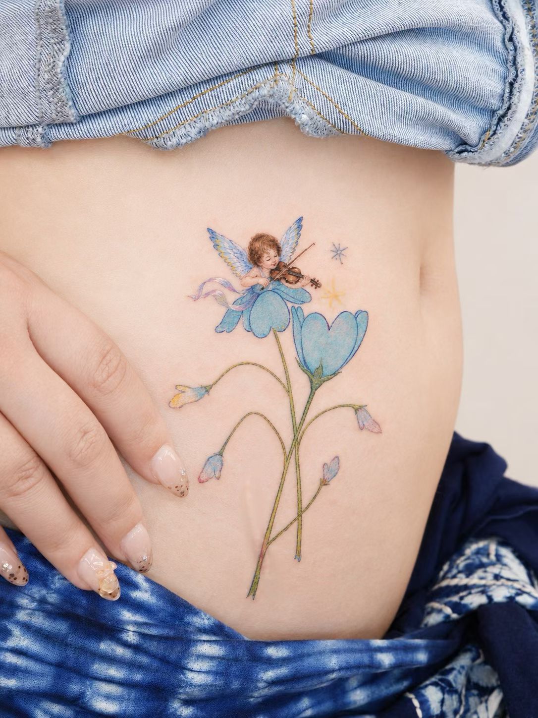 Delicate botanical colour tattoo flowing along the body